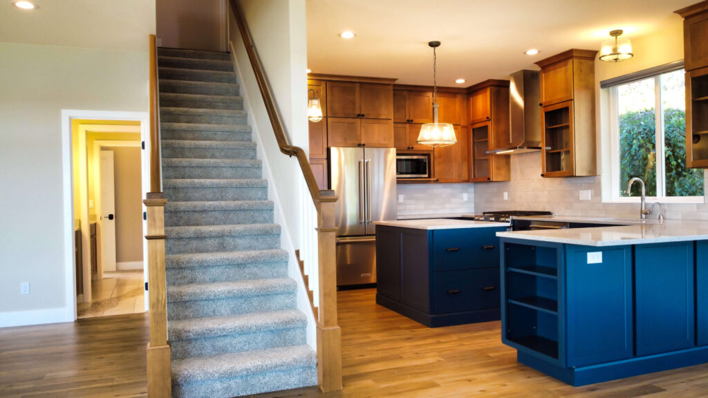 Custom Home Builder in Grapeview with custom staircase near kitchen