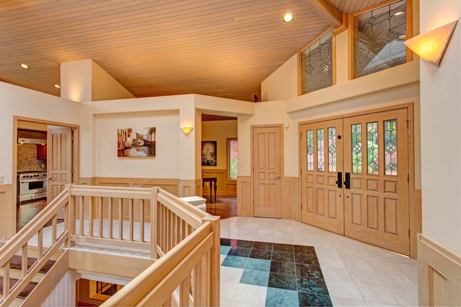 chic grand entrance foyer design with double sided staircase