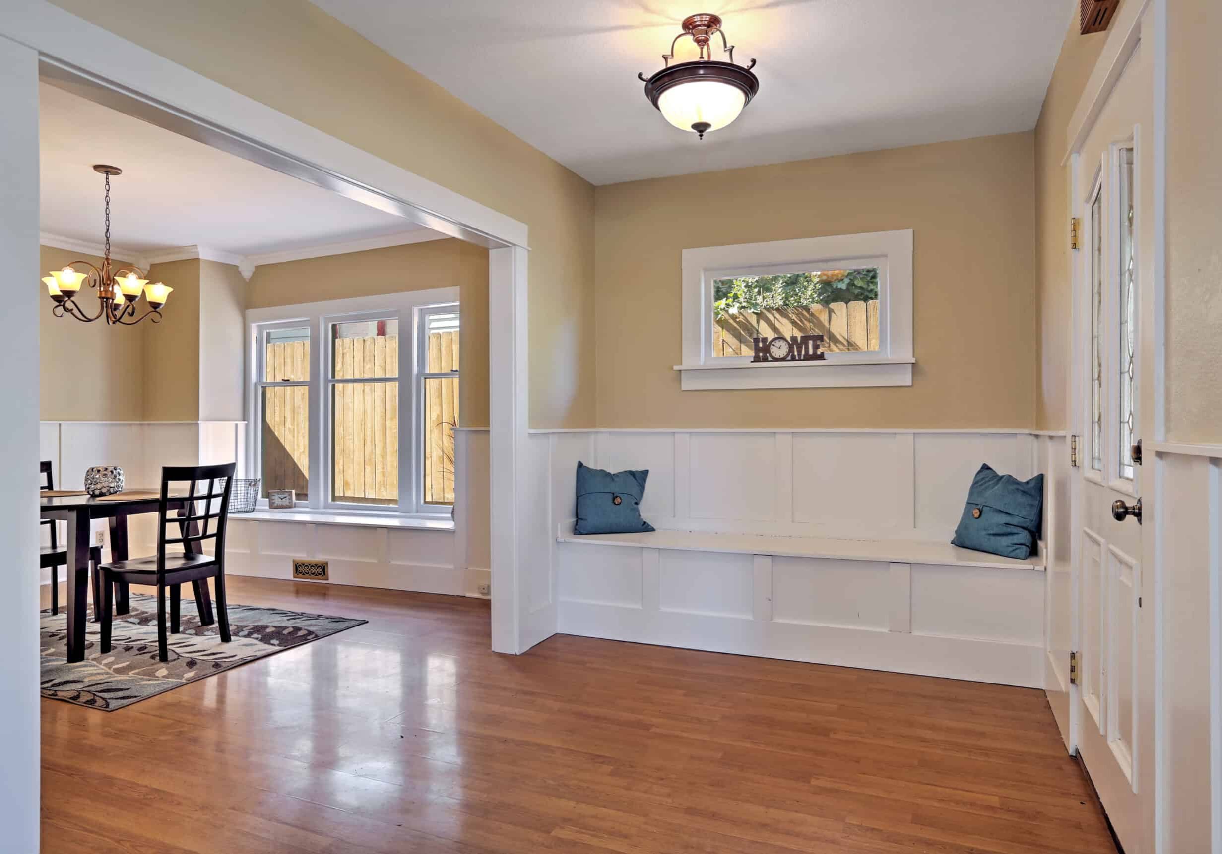 entrance hall with wood paneled walls and comfortable seat