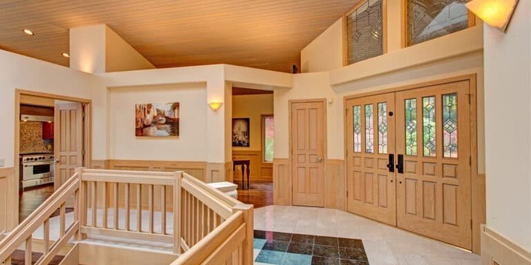 chic grand entrance foyer design with double sided staircase